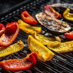 Grilled vegetables on barbecue, outdoor BBQ grill with fire. Top view